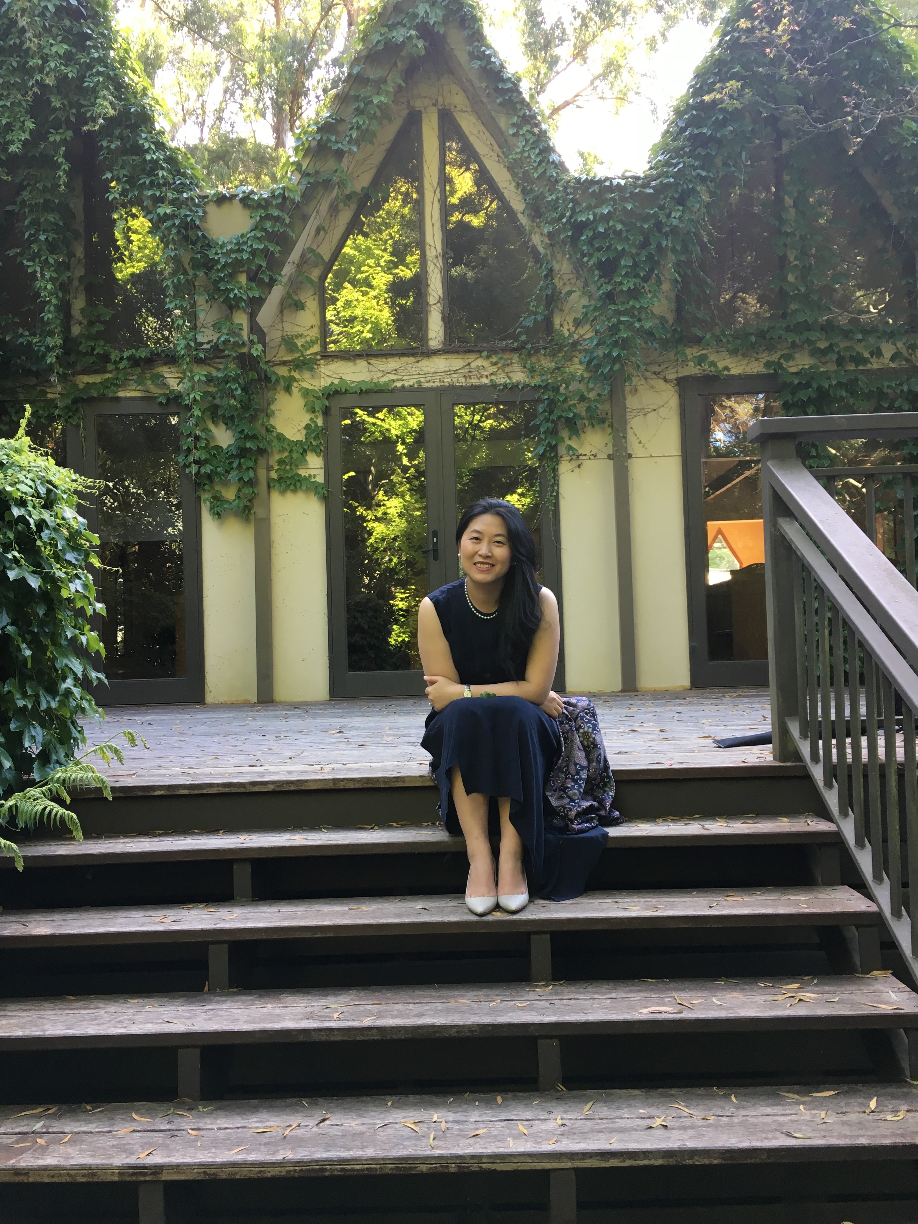 Chun Yin seated outside among greenery